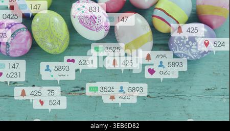 Showing cluster of decorated Easter eggs sitting on worn turquoise table, with notification bubbles Stock Photo
