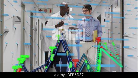 Walking doctors consulting in hospital hallway in lab coats holding tablet while AR overlays frame Stock Photo