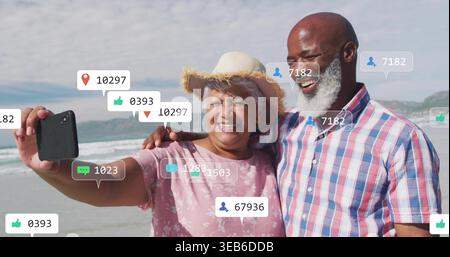 Taking selfie, couple at beach holding smartphone wearing straw sun hat checked shirt, overlays Stock Photo