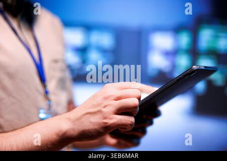 Admin checking interlinked computers creating server network, close up. Supercomputers in blurry background using parallel computing to perform complex calculations and process vast amounts of data Stock Photo