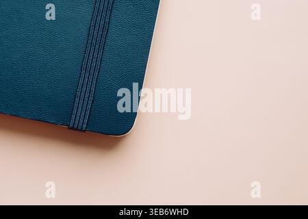 Closed blue notebook on beige background in minimal style Stock Photo