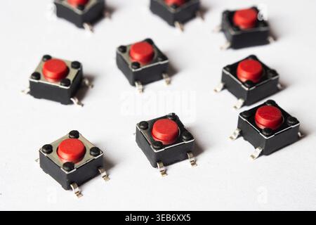 Red tactile push buttons on white background arranged in pattern Stock Photo