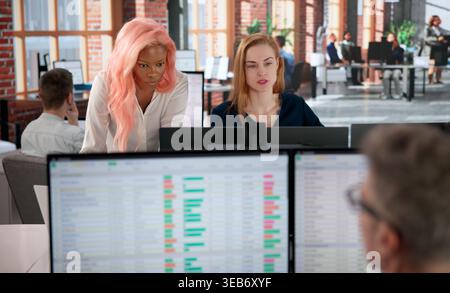 Billing Analyst Studies Medical Bills And Account Codes On Computer Screen Carefully. Stock Photo