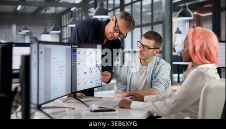 Business Manager Uses Computer Screen For Diverse Team's Online Planning Session. Stock Photo