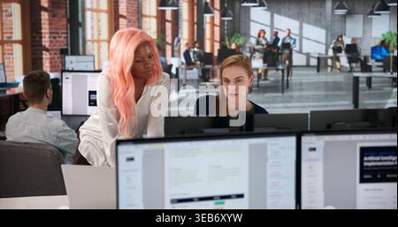 Business Analyst Studies Detailed Risk Data On Office Computers Today Carefully. Stock Photo