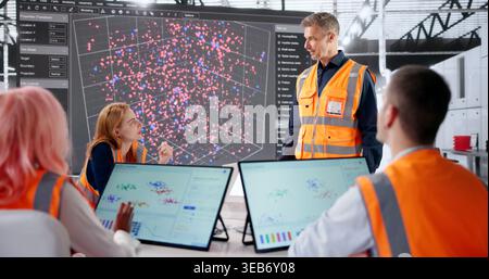 Data Scientist Leads Diverse Team Analyzing Industrial Mining Automation Systems. Stock Photo
