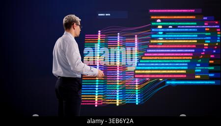 Hispanic Man Exploring Big Data Clustering On A High-Tech Interactive Display Stock Photo