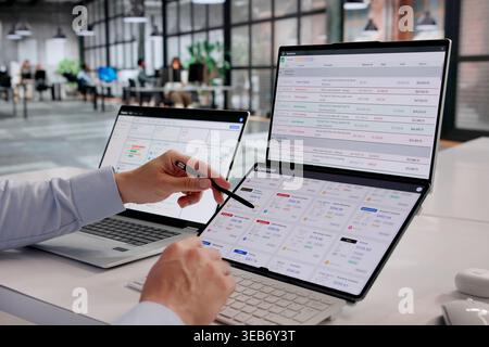Finance Manager Analyzing Expense Reports With Sophisticated Tracking Tools Stock Photo