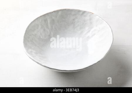 empty white bowl on white kitchen table Stock Photo