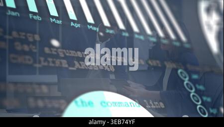 Analyzing pros in suits leaning over laptop and tablet at boardroom, viewing bar chart and code Stock Photo