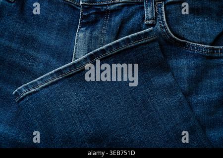 Denim jeans pocket and hem detail showing stitching and fabric texture Stock Photo