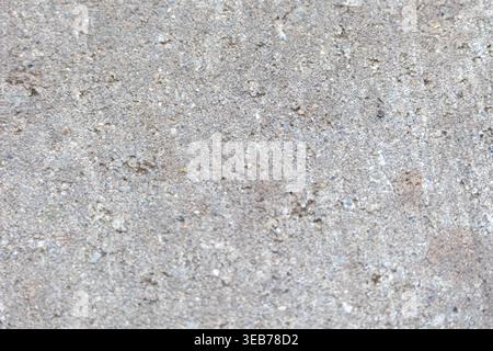 Gray concrete surface showing a rough and gritty texture with visible aggregate Stock Photo