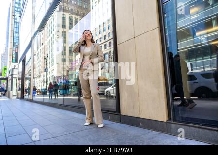 Successful businesswoman talking on smartphone in manhattan Stock Photo