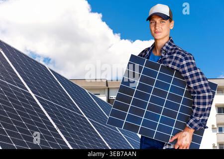 Woman holding solar panel. Renewable energy in city. Stock Photo