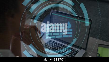 Displaying laptop HUD showing firewall icon on desk, woman in casual top reading code, green tablet Stock Photo