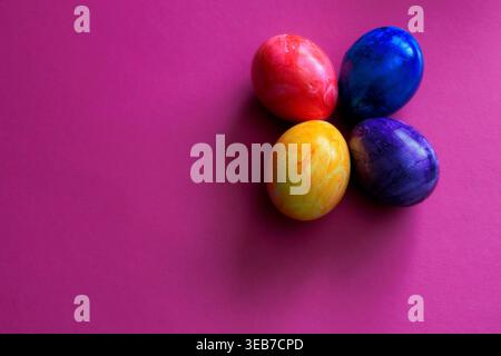 Different colored Easter eggs on a colored background Stock Photo