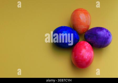 Different colored Easter eggs on a colored background Stock Photo