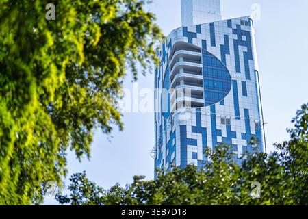 Batumi, georgia 21 april 2026: batumi technological university tower showcasing innovative design and reflective patterns against a clear blue sky, fr Stock Photo
