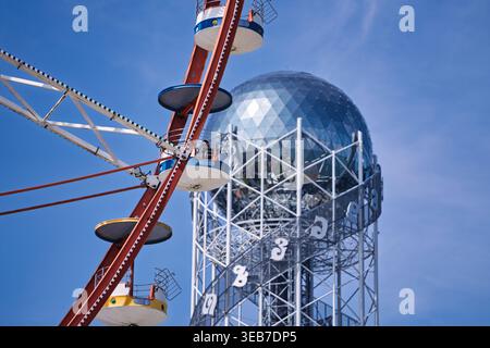 Batumi, georgia 21 april 2026: batumi, georgia, featuring the alphabetic tower with its distinctive letters and a vibrant amusement park ferris wheel Stock Photo