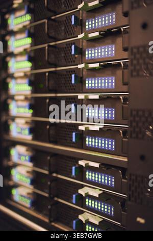 Closeup, servers and rack in empty data center for cybersecurity, IT hardware and infrastructure. Mainframe, network and database machine for power Stock Photo