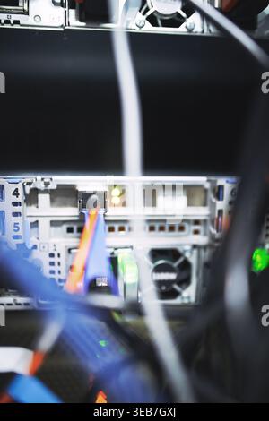 Closeup, rack and mainframe cables at data center for database, IT infrastructure and backup system. Dashboard, ethernet and server panel with Stock Photo