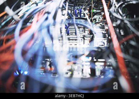 Closeup, rack and mainframe cables in server room for database, IT infrastructure and backup system. Hardware, ethernet and optical panel with Stock Photo