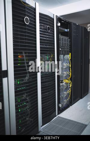 Storage, servers and network in empty data center for cybersecurity, IT hardware and infrastructure. Interior, mainframe and database machine for Stock Photo