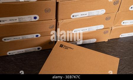 Jurmala, Latvia - 12.12.2025: Boxes of Bambu Lab filament stacked in a warehouse ready for shipping and distribution in the afternoon Stock Photo
