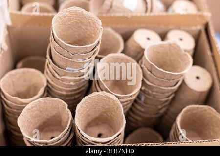 Biodegradable seedling pots paper pulp on wooden table ideal for flowerpot garden balcony ,seeding plant cultivation. Stock Photo