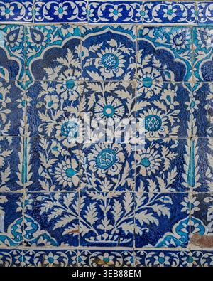 Closeup view of ancient traditional blue and white ceramic tiles floral motif on exterior wall of Makhdum Nuh tomb, Hala, Sindh, Pakistan Stock Photo