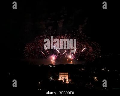 Fireworks in red and gold over Antibes bay with historic landmark Stock Photo