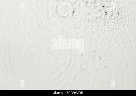 Clear water surface creating ripple effect and small air bubbles Stock Photo