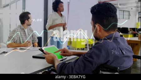 Using tablet, man in patterned shirt tapping in office, showing green-screen and data overlays Stock Photo