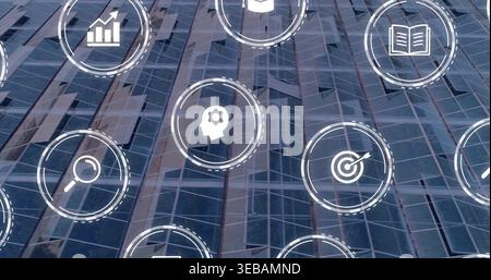 Projecting white tech icon grid including search and analytics on glass curtain wall Stock Photo
