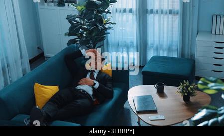 Top view of stressful project manager talking to smart team by using phone. Professional business man making phone call to colleague while working on Stock Photo