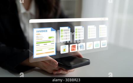 A professional individual holds a smartphone displaying a digital invoice management system. This showcases innovative technology to enhance business Stock Photo