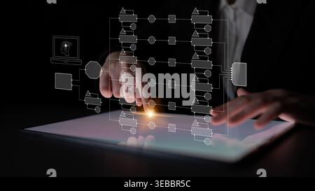 Business Professional Using Digital Tablet with Graphic Interface and Flowchart Concepts for Modern Analysis and Technology Solutions in Dark Setting Stock Photo
