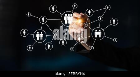 A person hand is depicted illustrating a network of connections and relationships between individuals, symbolizing engagement and collaboration in a Stock Photo