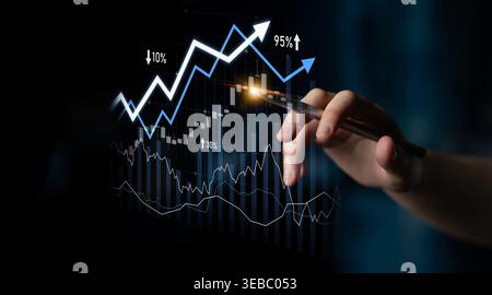 A close-up of a hand with a pen pointing at a financial graph displaying growth indicators, symbolizing progress and success in business analytics and Stock Photo