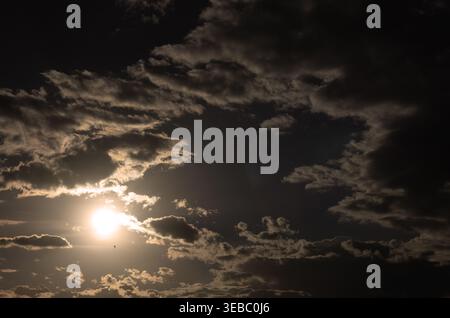 Dramatic evening sky. The sun is shining through the clouds. Stock Photo