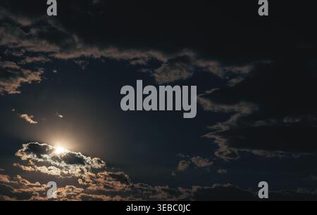 Dramatic evening sky. The sun is shining through the clouds. Stock Photo