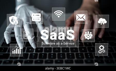 An innovative scene depicting a robotic hand interacting with a laptop, showcasing the concept of Software as a Service in a modern digital workspace Stock Photo