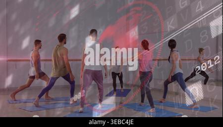 Leading instructor in activewear guiding five peers lunging on blue mats in studio with mirror HUD Stock Photo