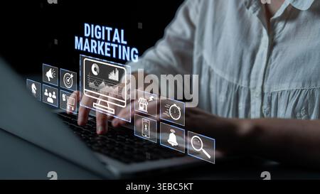 Professional Hands Typing on Laptop with Digital Marketing Interface Displaying Various Icons and Data Analytics Graphics for Online Promotion Stock Photo