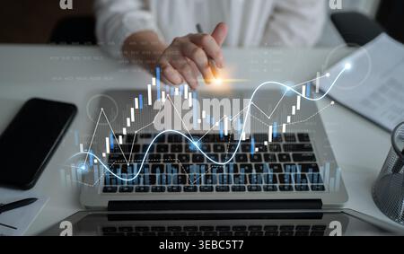 A professional businessperson analyzes financial data on a laptop, featuring graphs and market trends, highlighting modern investment strategies in a Stock Photo