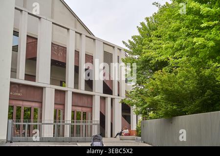 Modern architectural exterior of a contemporary building featuring tall vertical concrete columns and large brown metallic panels creating a Stock Photo