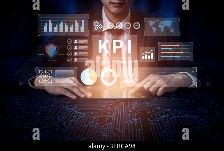 A businessman interacts with a digital interface showcasing key performance indicators in a modern workspace, highlighting data analysis and strategic Stock Photo