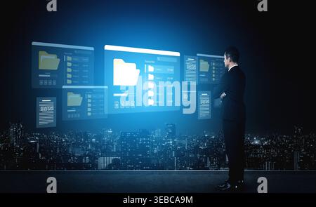 A businessman stands in front of holographic screens displaying digital data in a modern cityscape. This image captures the essence of innovation and Stock Photo