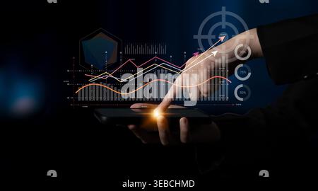 A hand interacts with a smartphone displaying vibrant data visualization. The image represents modern analytics and trends, highlighting performance Stock Photo