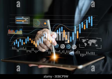 Business professional engages with a digital tablet, analyzing financial trends through interactive visual graphs, demonstrating skill and modern Stock Photo